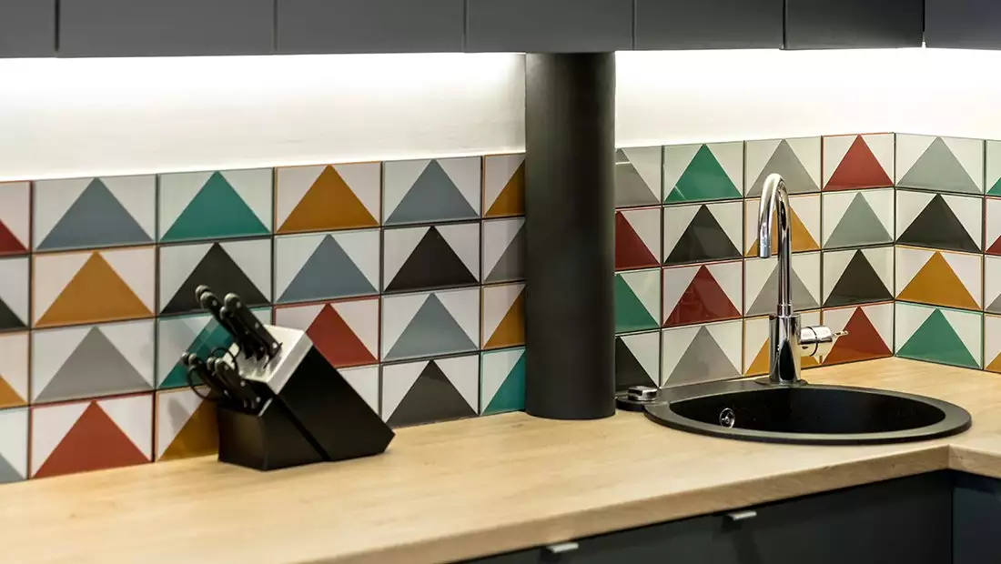 Kitchen Backsplash featuring Triangular-Patterned, Multi-Color Tiles